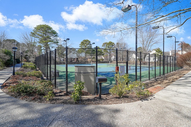 view of tennis court featuring fence