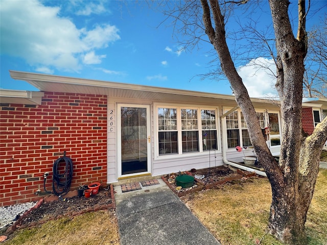 entrance to property with brick siding