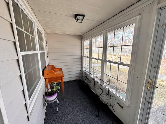 sunroom / solarium featuring wood ceiling