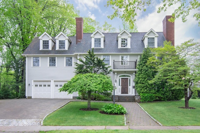 6 Hazen St, Pelham, NY 10803 - view of front of home with a chimney, a balcony, driveway, and an attached garage