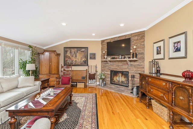 living area with a fireplace, crown molding, lofted ceiling, recessed lighting, and wood finished floors