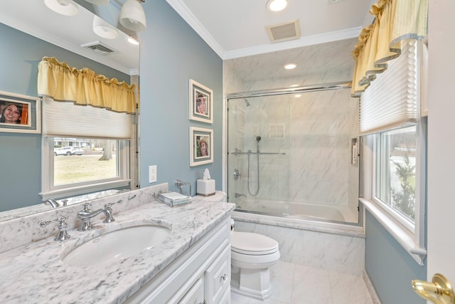 bathroom with shower / bath combination with glass door, vanity, visible vents, and ornamental molding