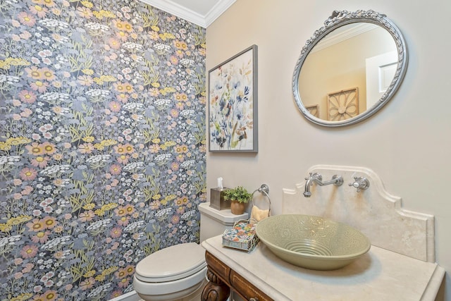 bathroom with ornamental molding, a sink, and toilet