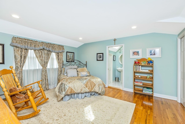 bedroom with vaulted ceiling, recessed lighting, wood finished floors, and baseboards