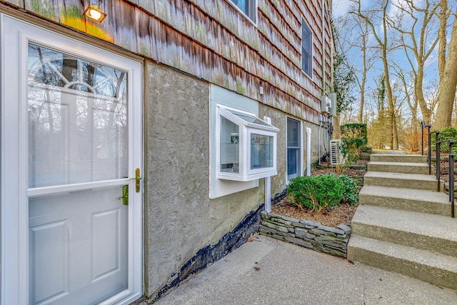 property entrance with stucco siding