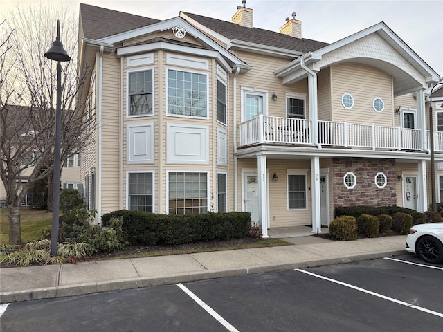 view of property featuring uncovered parking