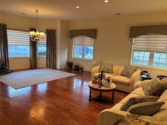 living room featuring an inviting chandelier, visible vents, wood finished floors, and recessed lighting