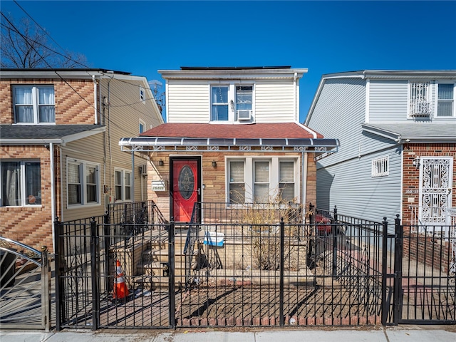 view of front facade featuring a fenced front yard and cooling unit