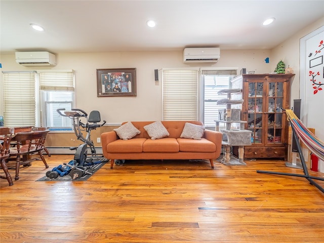 living room featuring light wood-type flooring, recessed lighting, and a wall mounted AC