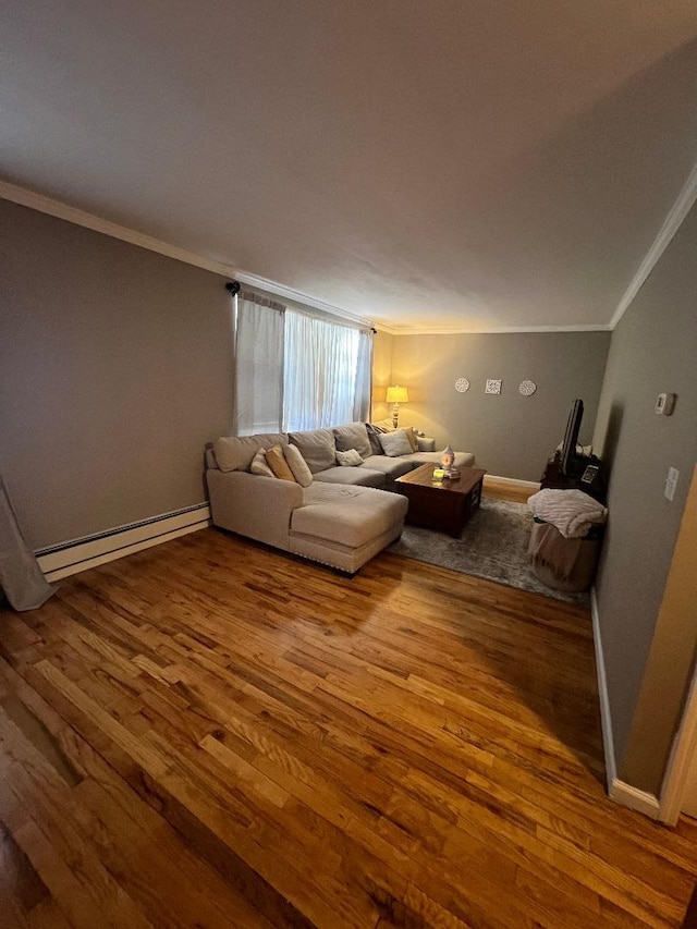 unfurnished living room with baseboards, a baseboard heating unit, wood finished floors, and ornamental molding