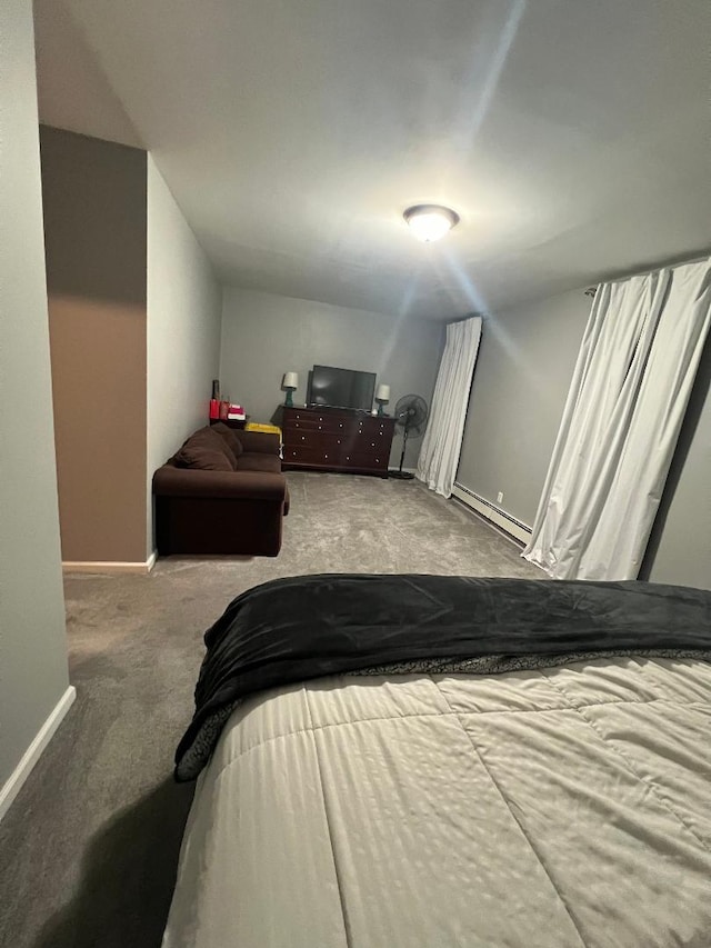 carpeted bedroom featuring baseboards and a baseboard heating unit