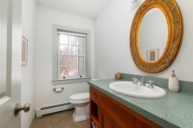 bathroom with toilet, baseboard heating, vanity, and baseboards