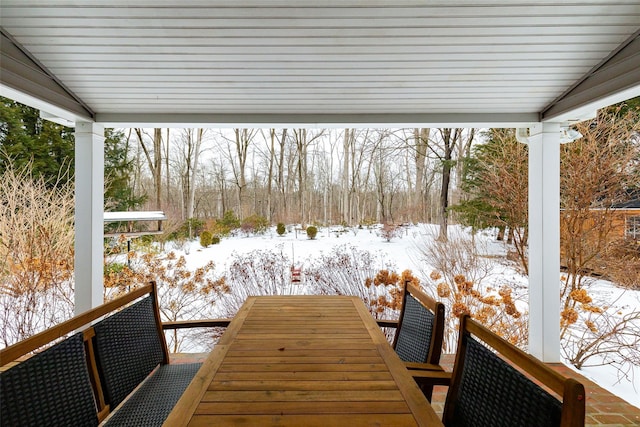 snow covered deck with outdoor dining space