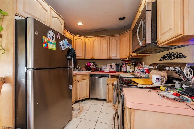 kitchen with light tile patterned floors, light brown cabinets, stainless steel appliances, and light countertops