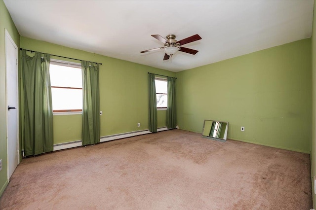 spare room featuring a ceiling fan, light colored carpet, and baseboard heating