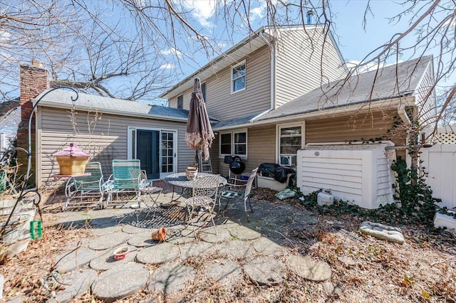 back of property with a patio and fence