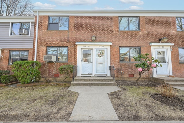 multi unit property featuring brick siding, crawl space, and cooling unit