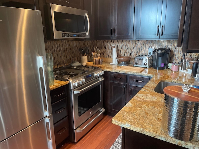 83-55 Lefferts Blvd Apt # 6F, Kew Gardens, NY 11415 - kitchen featuring stainless steel appliances, a sink, tasteful backsplash, and light stone counters