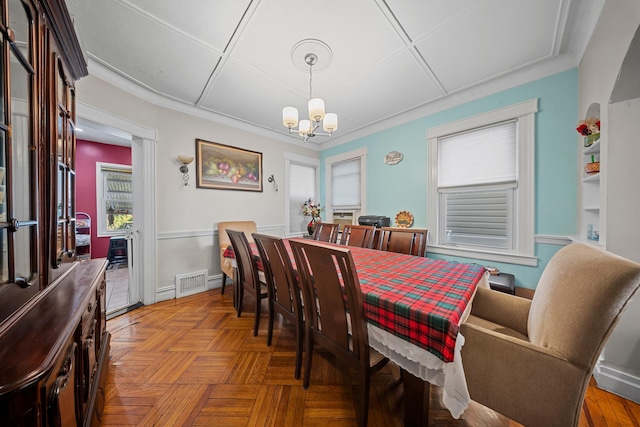 dining space featuring baseboards, visible vents, and a notable chandelier