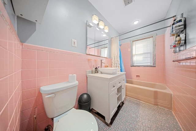 full bath with toilet, visible vents, tile walls, and tile patterned floors