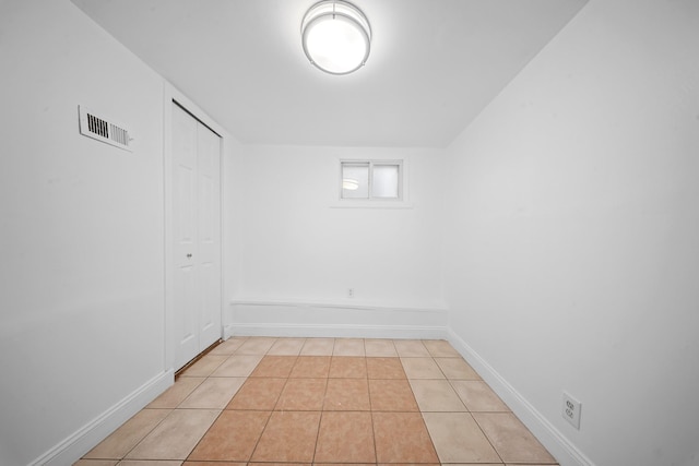 unfurnished room with visible vents, baseboards, and light tile patterned flooring