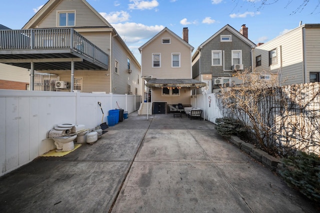 rear view of house with a patio and a fenced backyard