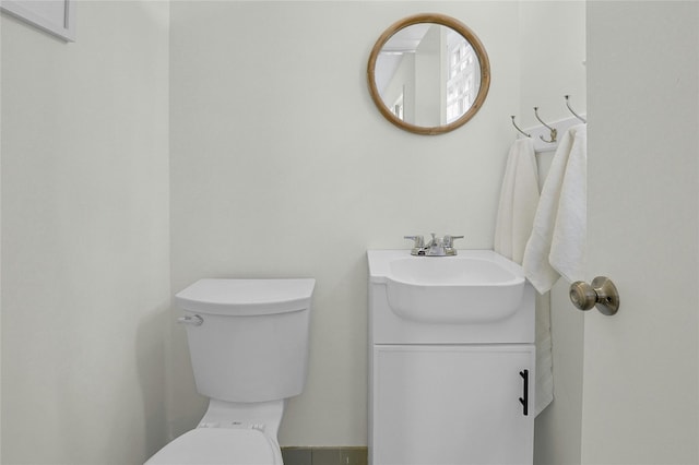 bathroom featuring toilet and vanity