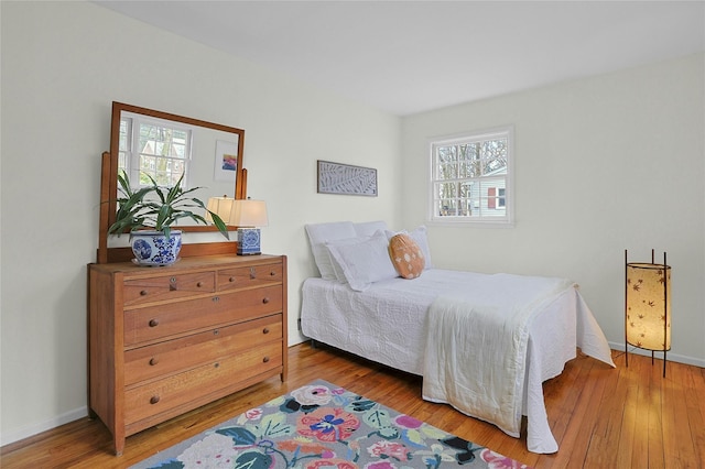 bedroom featuring wood-type flooring and baseboards