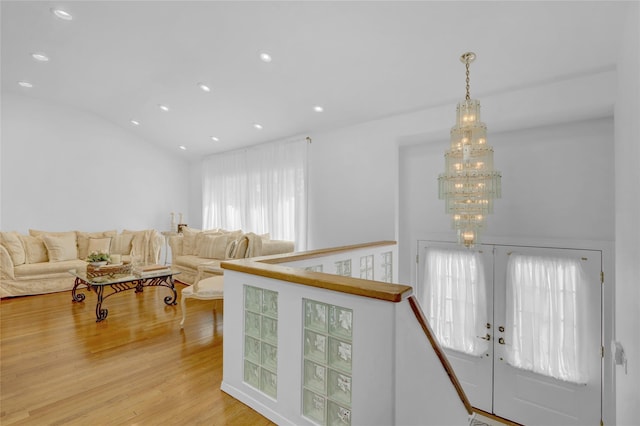 living area featuring a chandelier, french doors, light wood finished floors, and recessed lighting