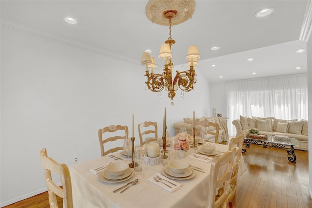 dining space featuring a chandelier, recessed lighting, baseboards, and hardwood / wood-style flooring