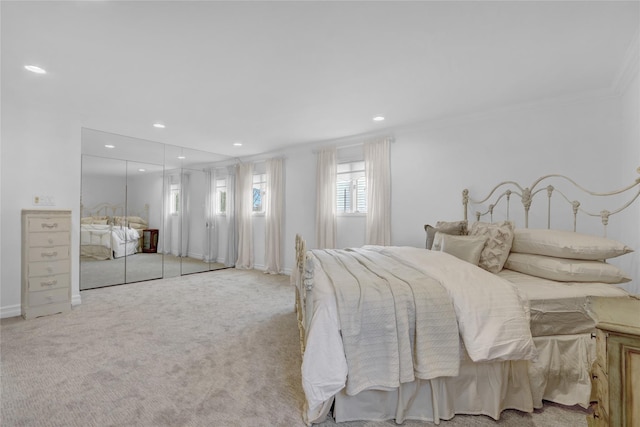 carpeted bedroom featuring baseboards, ornamental molding, and recessed lighting