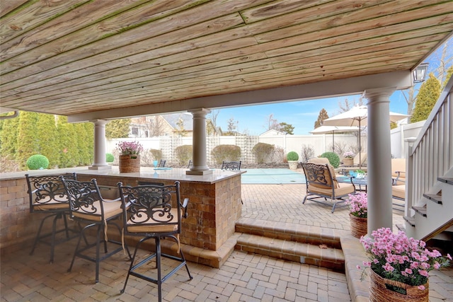 view of patio / terrace with a fenced backyard and outdoor dry bar