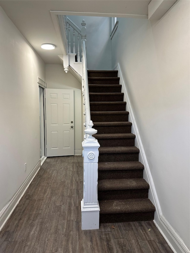 stairs with baseboards and wood finished floors