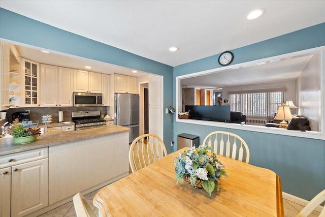 dining room with recessed lighting and light tile patterned floors