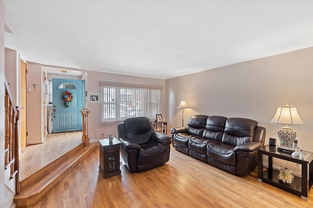 living area featuring stairs and wood finished floors