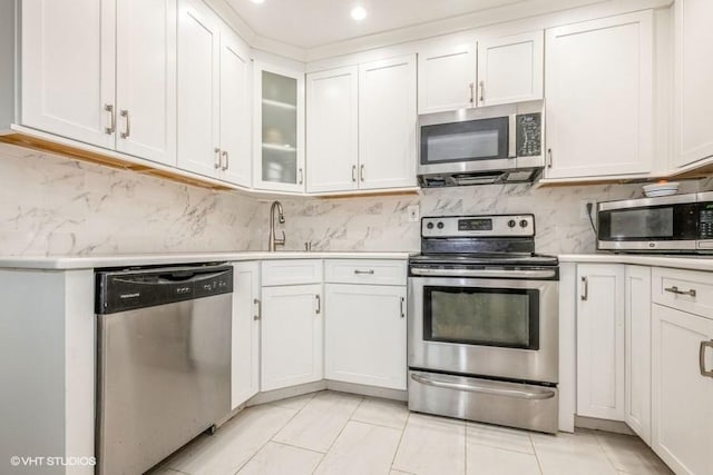 18 Old Farm Rd, Levittown, NY 11756 - kitchen featuring appliances with stainless steel finishes, light countertops, white cabinetry, tasteful backsplash, and recessed lighting