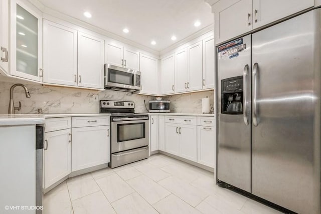 18 Old Farm Rd, Levittown, NY 11756 - kitchen with stainless steel appliances, light countertops, backsplash, white cabinetry, and recessed lighting