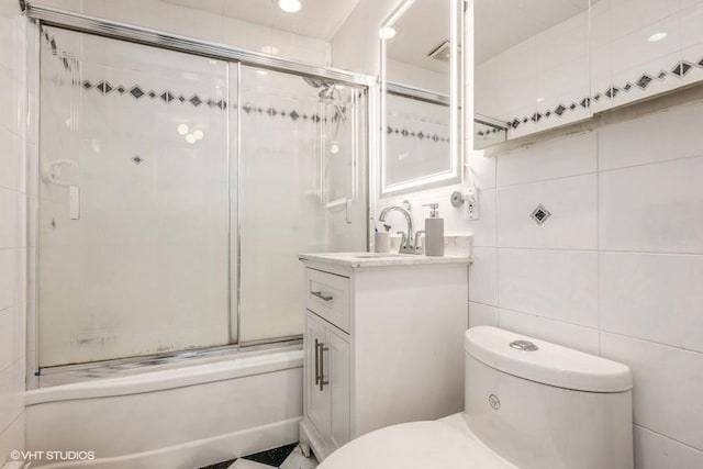 18 Old Farm Rd, Levittown, NY 11756 - full bathroom featuring vanity, shower / bath combination with glass door, tile walls, and recessed lighting
