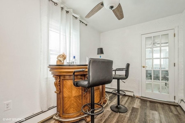 18 Old Farm Rd, Levittown, NY 11756 - indoor dry bar with a baseboard heating unit, ceiling fan, and wood finished floors