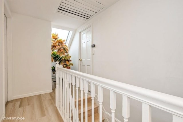 18 Old Farm Rd, Levittown, NY 11756 - corridor featuring light wood-style flooring and an upstairs landing