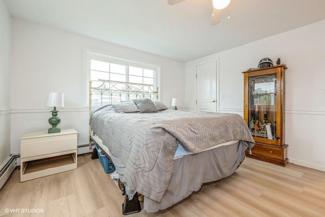 18 Old Farm Rd, Levittown, NY 11756 - bedroom featuring light wood finished floors, baseboard heating, and ceiling fan