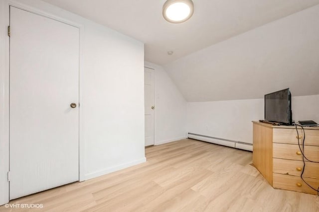 18 Old Farm Rd, Levittown, NY 11756 - additional living space featuring a baseboard heating unit, light wood-style flooring, and lofted ceiling