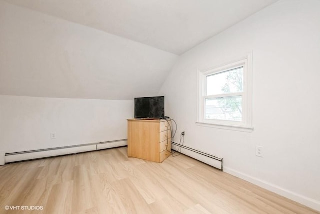 18 Old Farm Rd, Levittown, NY 11756 - additional living space with a baseboard heating unit, light wood finished floors, and vaulted ceiling