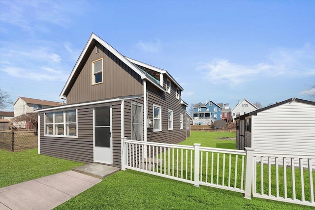 view of front of property with a front yard and fence