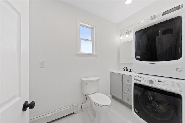 bathroom featuring stacked washer and dryer, baseboards, toilet, a baseboard radiator, and vanity