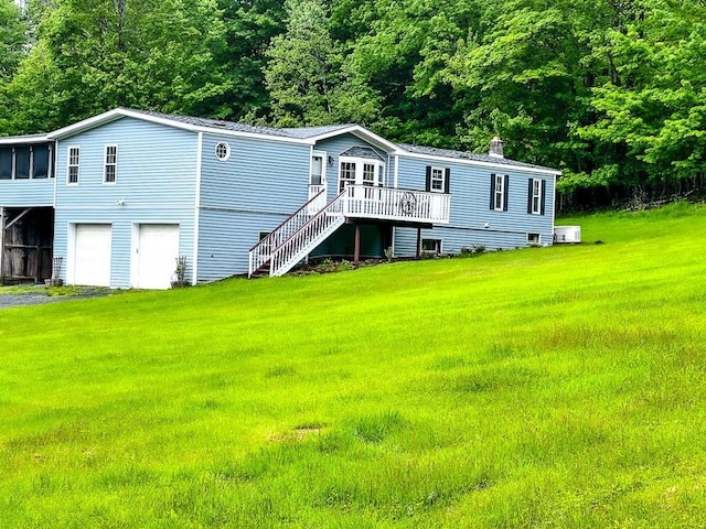521 Hessinger Lare Rd, Jeffersonville, NY 12748 - rear view of house featuring a wooden deck, an attached garage, stairway, a lawn, and a chimney