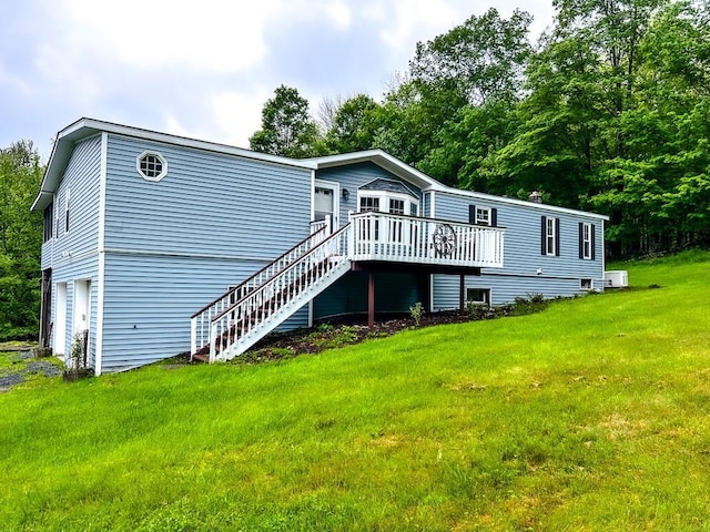 521 Hessinger Lare Rd, Jeffersonville, NY 12748 - rear view of property featuring a deck, a garage, a lawn, and stairs