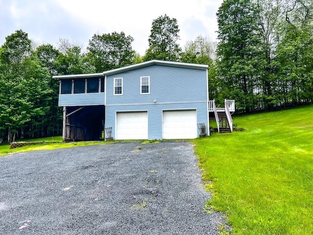 521 Hessinger Lare Rd, Jeffersonville, NY 12748 - view of front facade featuring stairs, a garage, a front yard, driveway, and a sunroom