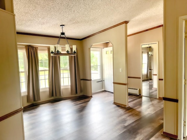 521 Hessinger Lare Rd, Jeffersonville, NY 12748 - unfurnished dining area with a baseboard radiator, wood finished floors, arched walkways, ornamental molding, and a textured ceiling