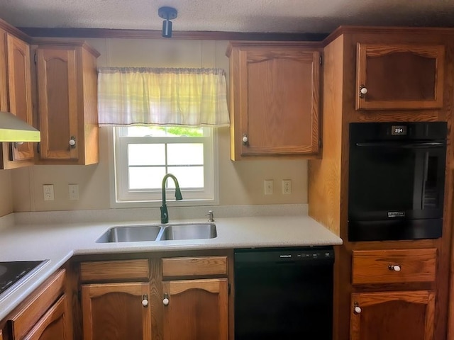 521 Hessinger Lare Rd, Jeffersonville, NY 12748 - kitchen with black appliances, light countertops, range hood, and brown cabinetry